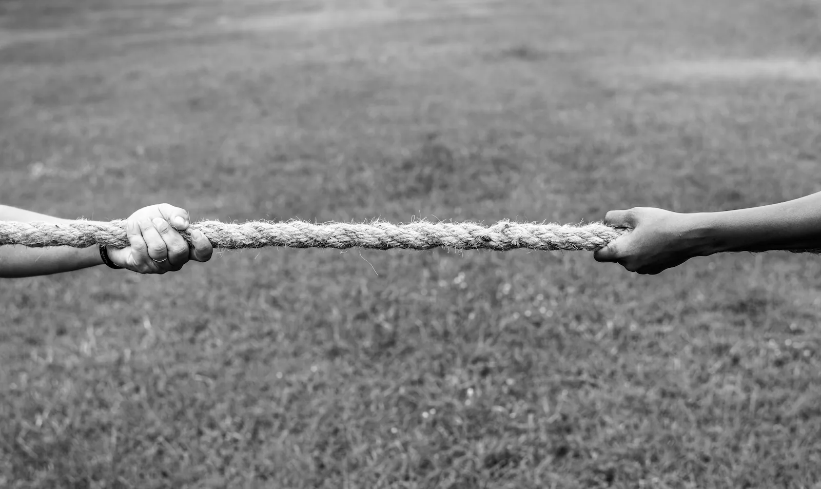 closeup-hand-pulling-rope-tug-war-game