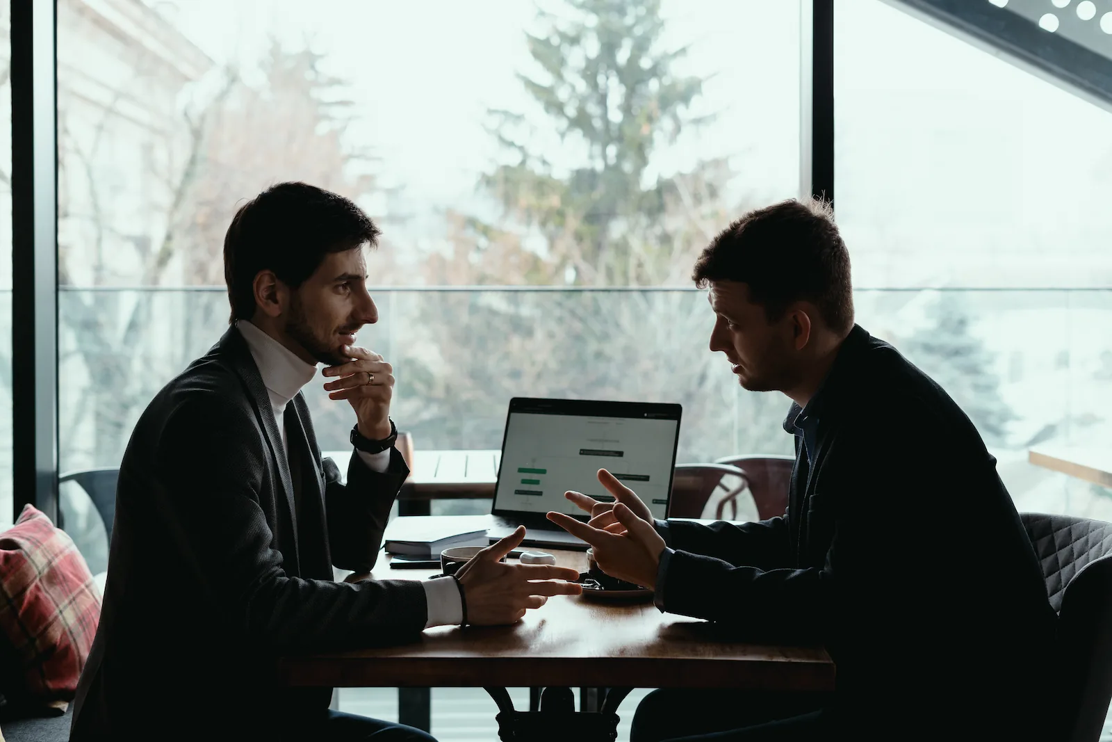 two-young-businessman-having-successful-meeting-restaurant